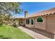 View of the home's backyard featuring a covered patio and well-maintained lawn at 1330 W Butler Dr, Chandler, AZ 85224