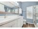 Stylish bathroom with double sinks, modern cabinetry, and a walk-in shower at 1330 W Butler Dr, Chandler, AZ 85224
