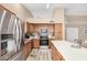 Modern kitchen featuring stainless steel appliances, a kitchen island with seating, and plenty of cabinet space at 1330 W Butler Dr, Chandler, AZ 85224