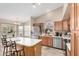Bright kitchen featuring stainless steel appliances, a white island, and a breakfast bar at 1330 W Butler Dr, Chandler, AZ 85224
