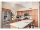 Well-equipped kitchen with stainless steel appliances, an island with seating, and ample cabinet space at 1330 W Butler Dr, Chandler, AZ 85224