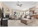 Inviting living room featuring a cozy fireplace, large sectional sofa, and open floor plan at 1330 W Butler Dr, Chandler, AZ 85224
