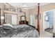 Comfortable main bedroom with four-poster bed, neutral tones, and a connecting bathroom at 1330 W Butler Dr, Chandler, AZ 85224