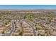 Expansive aerial view showcasing the neighborhood, surrounding landscape, and property with clear blue skies at 16264 W Pioneer St, Goodyear, AZ 85338