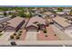 An aerial view displays the house with desert landscaping and a well-maintained lawn at 16264 W Pioneer St, Goodyear, AZ 85338
