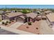 Charming exterior enhanced with desert landscaping in this aerial view of the house at 16264 W Pioneer St, Goodyear, AZ 85338