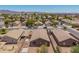 View of home in a neighborhood setting, with gravel landscaping, block fence, and covered patio at 16264 W Pioneer St, Goodyear, AZ 85338