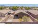 View of backyard featuring gravel landscaping, block fence, and covered patio at 16264 W Pioneer St, Goodyear, AZ 85338