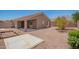 Expansive backyard featuring a covered patio and well-maintained desert landscaping at 16264 W Pioneer St, Goodyear, AZ 85338