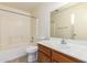 Bathroom featuring a tiled shower-tub, single sink vanity, and a large mirror at 16264 W Pioneer St, Goodyear, AZ 85338