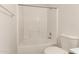 Bathroom showcasing a tiled shower-tub combination, and toilet at 16264 W Pioneer St, Goodyear, AZ 85338