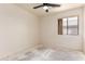 Bedroom with a window and ceiling fan offering a comfortable atmosphere at 16264 W Pioneer St, Goodyear, AZ 85338