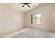 Empty bedroom features a ceiling fan and a window providing natural light at 16264 W Pioneer St, Goodyear, AZ 85338