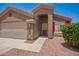 A welcoming front entrance, desert landscaping, and a convenient two-car garage at 16264 W Pioneer St, Goodyear, AZ 85338