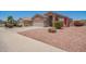 Lovely desert-landscaped home with mature bushes and colorful shutters at 16264 W Pioneer St, Goodyear, AZ 85338
