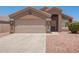 This home boasts a well-manicured yard, two-car garage, and inviting entryway at 16264 W Pioneer St, Goodyear, AZ 85338