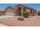 Inviting single-story home with well-kept landscaping, charming shutters, and a two-car garage at 16264 W Pioneer St, Goodyear, AZ 85338