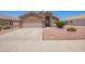 Charming single-story home featuring a two-car garage and low-maintenance desert landscaping at 16264 W Pioneer St, Goodyear, AZ 85338