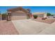 A beautiful desert-landscaped home with a spacious driveway and two-car garage at 16264 W Pioneer St, Goodyear, AZ 85338