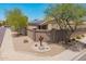 Front yard featuring desert landscaping, a block fence, and mature trees providing shade at 16264 W Pioneer St, Goodyear, AZ 85338