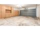 Spacious garage with ample storage cabinets and an overhead door ready for use at 16264 W Pioneer St, Goodyear, AZ 85338