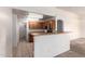 Kitchen features wood cabinets, appliances and access to the laundry area at 16264 W Pioneer St, Goodyear, AZ 85338