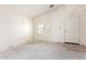 The expansive living room is a blank slate awaiting flooring and your personal touch at 16264 W Pioneer St, Goodyear, AZ 85338