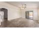 Open living room featuring a ceiling fan and sliding glass doors leading to the backyard patio at 16264 W Pioneer St, Goodyear, AZ 85338