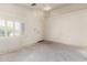 Bright living room features a large window, and entry into adjacent room at 16264 W Pioneer St, Goodyear, AZ 85338