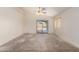 Spacious living room with a ceiling fan and sliding glass doors leading to the backyard at 16264 W Pioneer St, Goodyear, AZ 85338