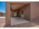 Large covered patio with stucco columns, providing a shady outdoor space and backyard access at 16264 W Pioneer St, Goodyear, AZ 85338