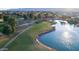 Beautiful aerial view of a golf course community, showcasing green fairways, sparkling lakes, and mountain views at 17449 N Fairway Dr, Surprise, AZ 85374