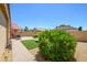 Well-kept backyard featuring neatly trimmed bushes, artificial turf, desert landscaping, and an inviting patio set at 17449 N Fairway Dr, Surprise, AZ 85374