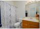 Clean bathroom featuring a vanity with a sink, a toilet, and a shower with a curtain at 17449 N Fairway Dr, Surprise, AZ 85374