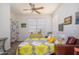 Bright bedroom with a ceiling fan, white walls, and a decorative bedspread at 17449 N Fairway Dr, Surprise, AZ 85374