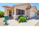 Welcoming home entrance with desert landscaping and a whimsical cactus statue at 17449 N Fairway Dr, Surprise, AZ 85374