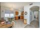 Spacious open floor plan showcasing the kitchen with wood cabinets and an adjacent dining area with a chandelier at 17449 N Fairway Dr, Surprise, AZ 85374