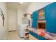 Functional laundry room featuring a washer, dryer, and custom storage solutions at 17449 N Fairway Dr, Surprise, AZ 85374