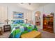 Cozy bedroom with a quilt-covered bed, shuttered windows, and access to the bathroom at 17449 N Fairway Dr, Surprise, AZ 85374
