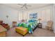 Bright and airy bedroom featuring a ceiling fan, shuttered windows, and a comfortable quilt-covered bed at 17449 N Fairway Dr, Surprise, AZ 85374