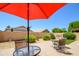 Outdoor patio with red umbrella and an outdoor seating area at 17449 N Fairway Dr, Surprise, AZ 85374