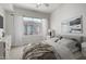 Bright bedroom features neutral tones, a large window, and soft textures for a calming retreat at 1920 E Bell Rd # 1165, Phoenix, AZ 85022
