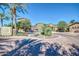 Elegant entrance to a gated community with lush landscaping and mature palm trees at 1920 E Bell Rd # 1165, Phoenix, AZ 85022