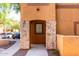Inviting entrance of townhome featuring stone columns and address number 1165 at 1920 E Bell Rd # 1165, Phoenix, AZ 85022