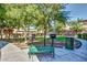 Outdoor grill area with benches and walkway surrounded by mature trees and green spaces at 1920 E Bell Rd # 1165, Phoenix, AZ 85022