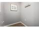 Hallway with neutral paint, dark wood-look floors, and simple hooks at 1920 E Bell Rd # 1165, Phoenix, AZ 85022