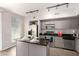 Modern kitchen features stainless steel appliances, granite countertops, and a functional center island at 1920 E Bell Rd # 1165, Phoenix, AZ 85022