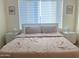 Bright bedroom featuring neutral walls, a window with blinds, and simple decor at 20952 E Via Del Sol --, Queen Creek, AZ 85142