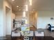 Modern dining room with stylish light fixtures that provides a stunning view of the adjacent kitchen at 20952 E Via Del Sol --, Queen Creek, AZ 85142