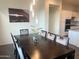 Elegant dining room with a dark wood table, velvet chairs, and modern lighting fixtures at 20952 E Via Del Sol --, Queen Creek, AZ 85142
